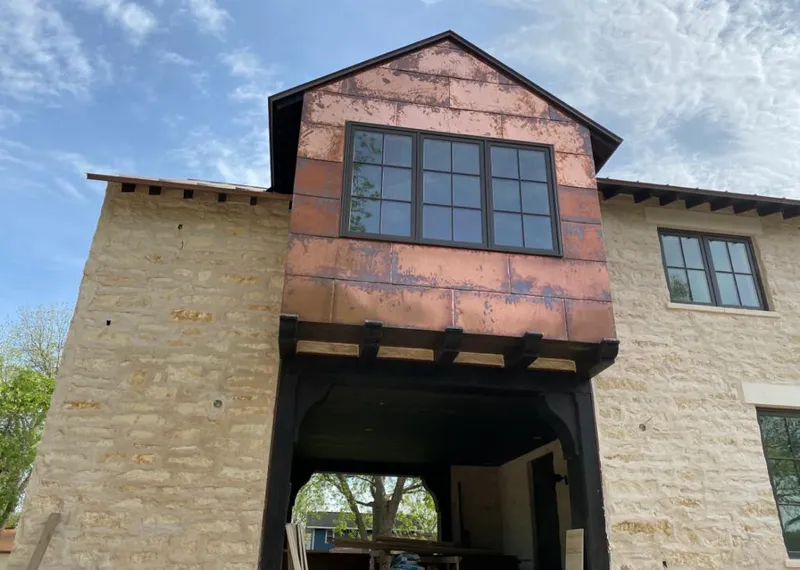 Copper metal panel facade on a stone building for Skylight Installation in Candler-McAfee