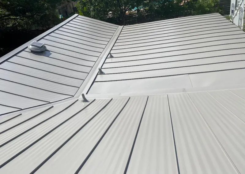 Solar attic fan installed on a metal roof for Roof Ventilation in Candler-McAfee